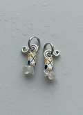 Small silver earrings with colorful beads on a gray background