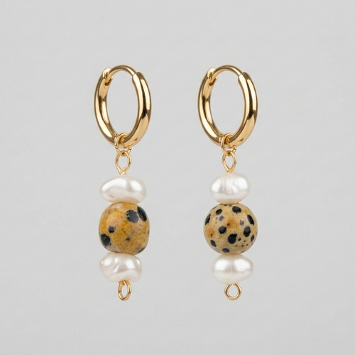 Gold hoop earrings with dalmatian jasper and pearl beads on a gray background